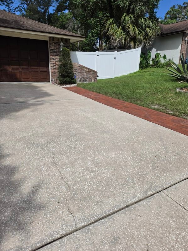 Clean concrete driveway by Magic Outdoor Solutions FL